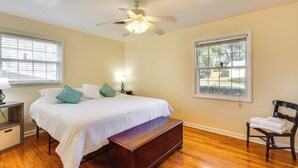 A bedroom with a bed, bedside table, lamp, bench, chair, and a ceiling fan. - 4 Mi to FSU! Family Gem w/ Deck in Tallahassee (Tallahassee)
