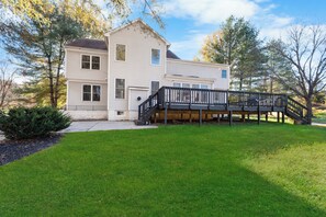 A two-story house with a covered deck and a front porch. - Luxury modern mansion/Cabin Near Washington DC-on over 4 Acres  of private land. (Upper Marlboro)