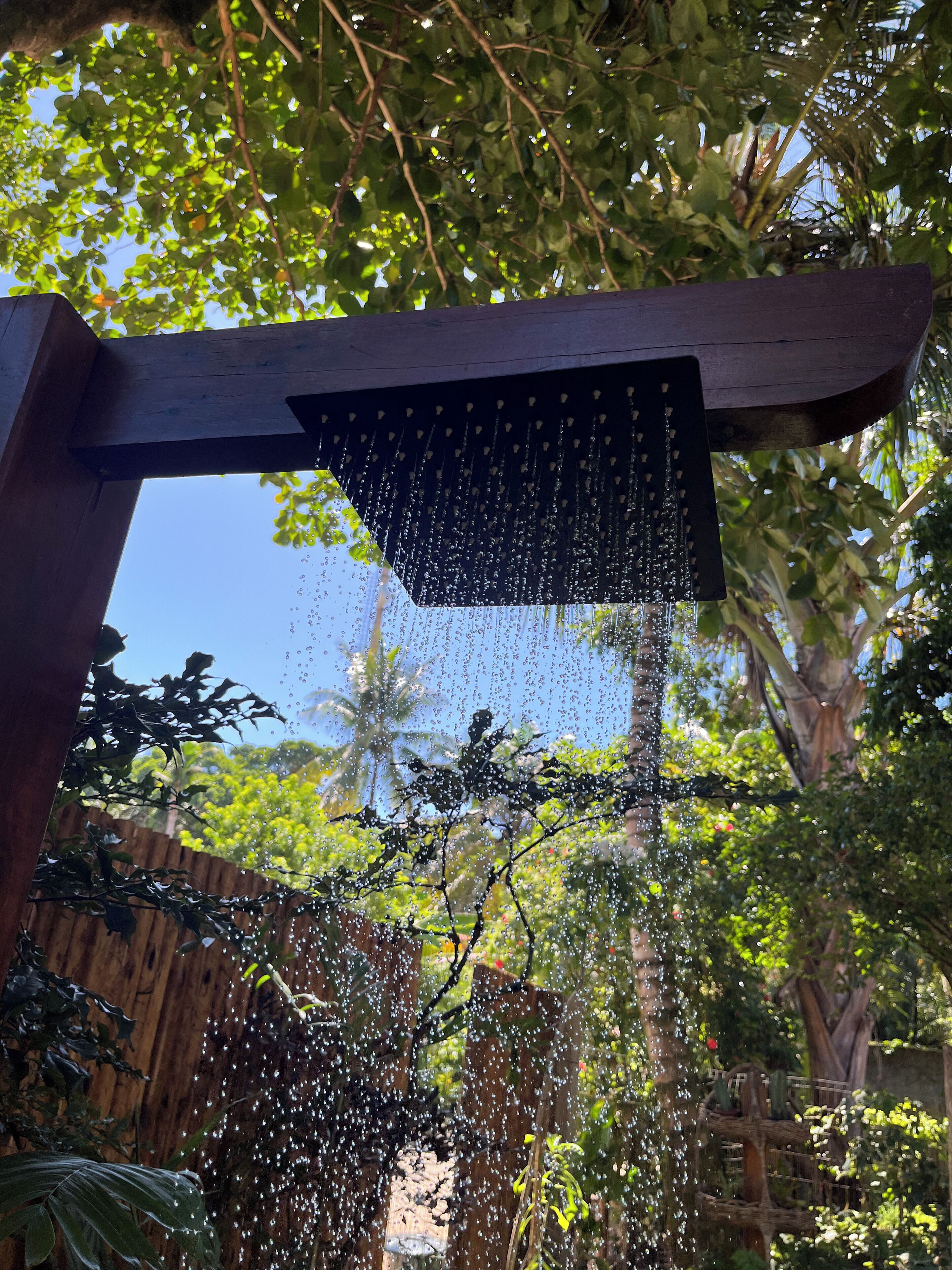 A wooden pergola with a water feature.