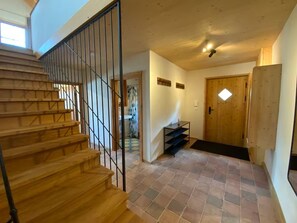 Stairs lead to an upper floor in this elegant hallway.