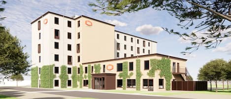 Un hotel moderno con varios pisos, una entrada central y un área exterior cubierta.