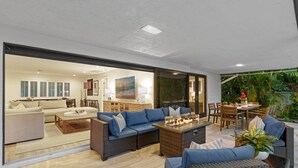 A modern living room with a large glass door leading to a dining area. - Boynton Beach Retreat, Close to Delray, Aug Deal (Boynton Beach)