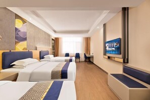 Two single beds with matching headboards and footboards, a flat-screen TV, and a desk with a chair.