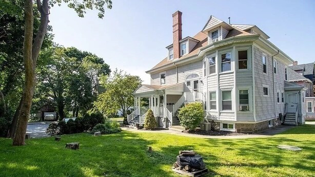 A large, two-story house with a wrap-around porch and a chimney. - Enjoyable Sunny 2-bedroom apartment with WiFi in Fall River Historical District (Fall River)