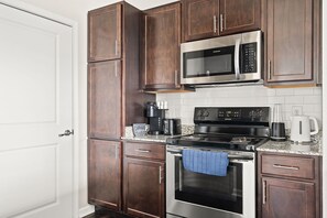 Enjoy cooking in this fully equipped kitchen with a microwave, stovetop, and coffee maker.