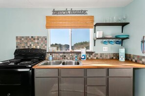 Fridge, cookware/dishes/utensils, dining tables - Hawaiian Themed Cottage | Ocean Views (Grayland)