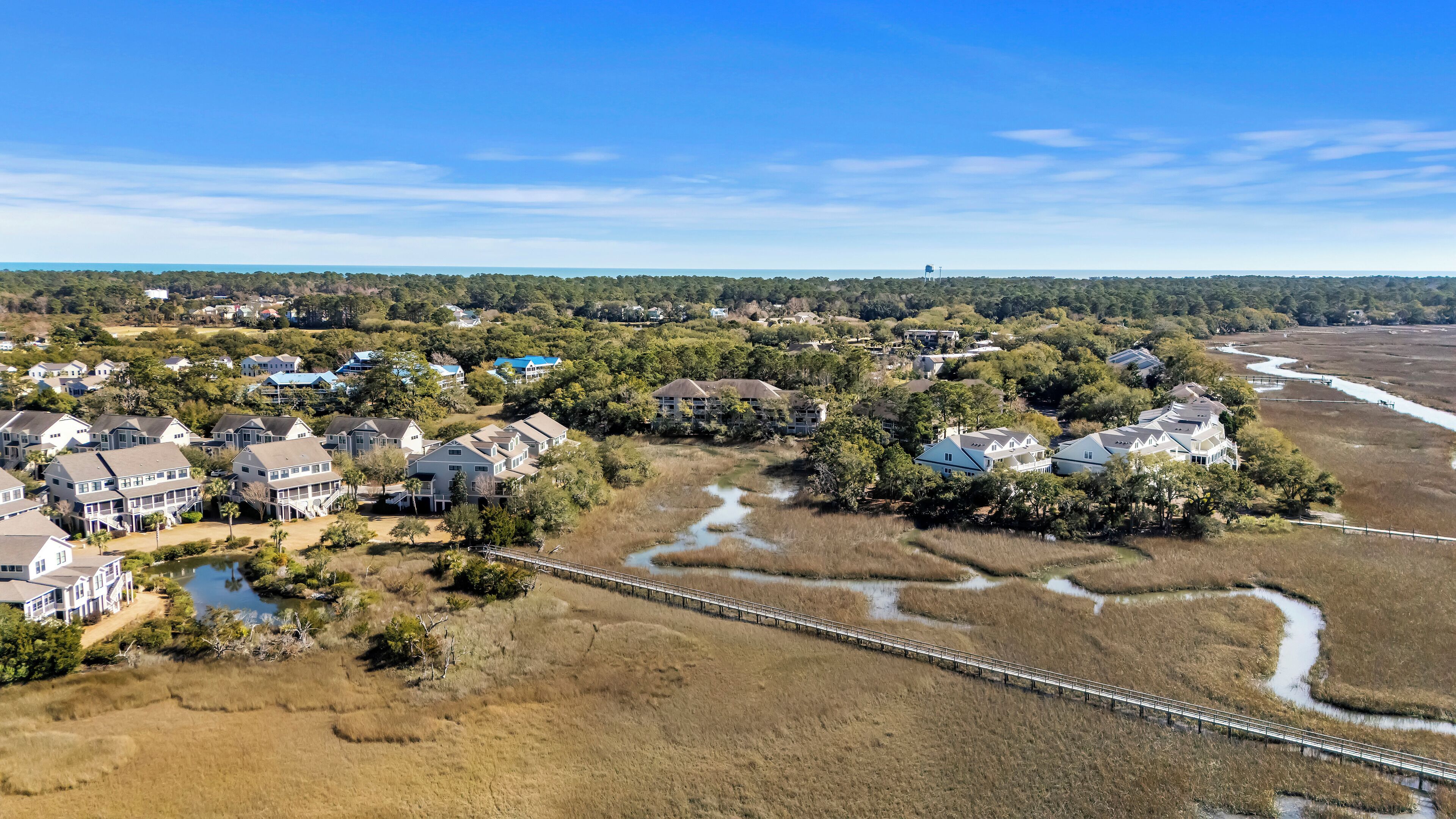 A coastal residential area with houses, a bridge, and a river.