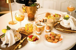 A breakfast setting with various food items, drinks, and utensils on a table. - Vaticano 13 guesthouse (Rome)