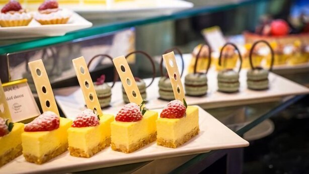 Un présentoir de desserts avec divers petits gâteaux et pâtisseries.