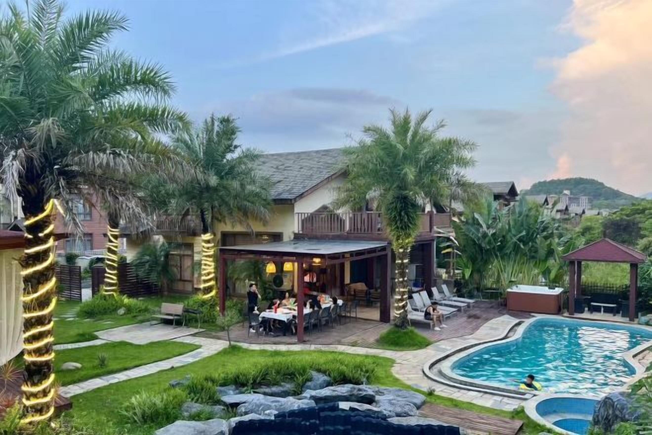 A pool area with a hot tub, outdoor seating, and a covered patio.