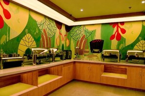A buffet setup with multiple serving stations and a wall mural. - HanTing Hotel (Yakeshi Xing'an Street) (Yakeshi)