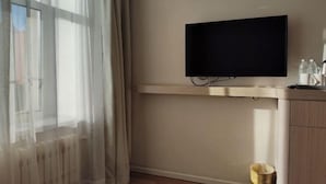A room with a mounted TV, a radiator, a window with curtains, and a waste bin. - HanTing Hotel (Yakeshi Xing'an Street) (Yakeshi)