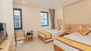 A hotel room with two beds, a desk, a chair, and a TV. - Viet Anh Ha Long Hotel (Bai Chay)