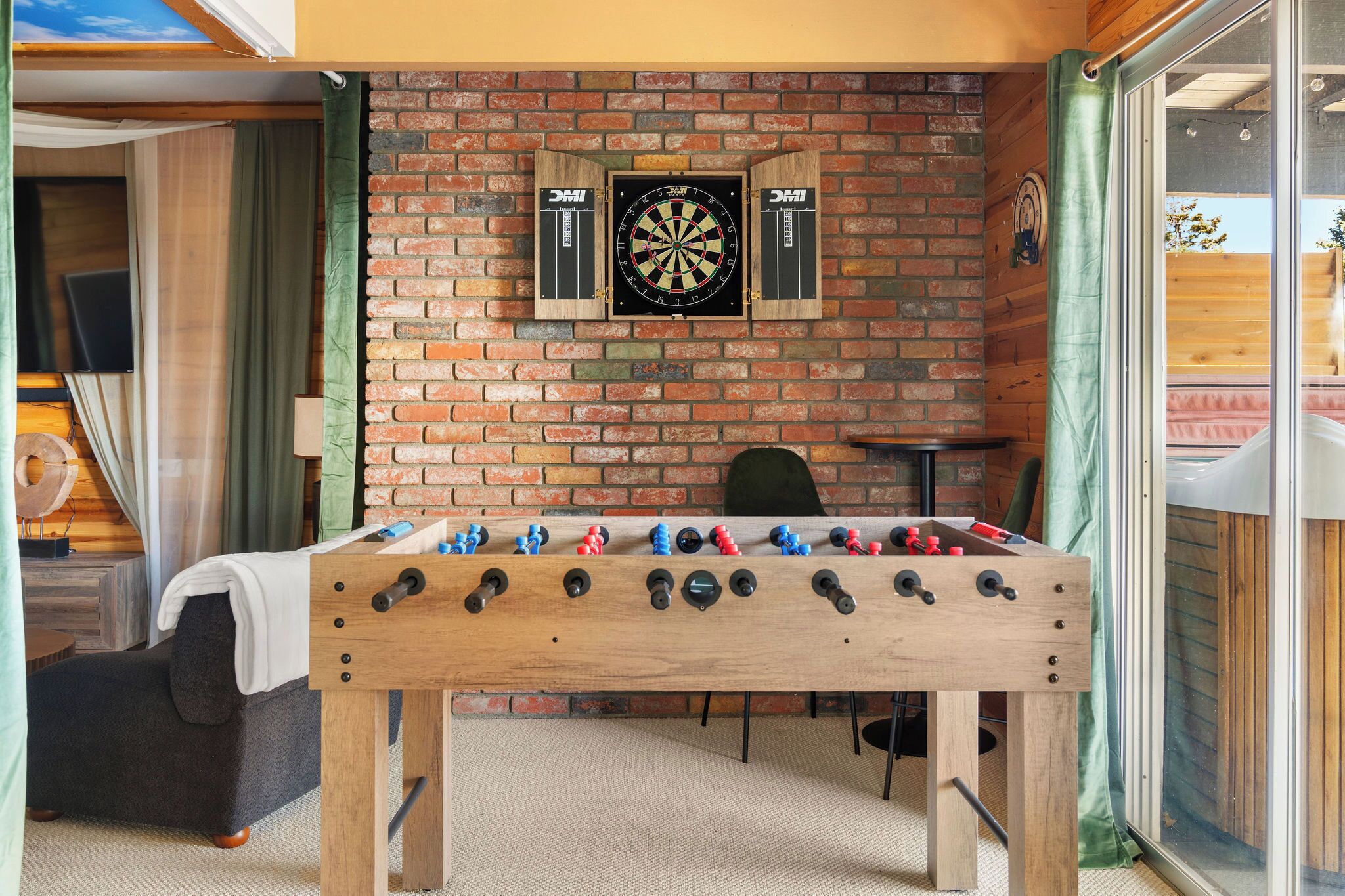 Regulation sized foosball table and darts in the back