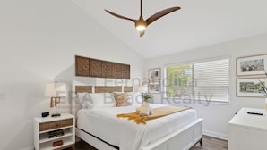 A bedroom with a bed, bedside tables, a ceiling fan, and artwork on the walls. - Experience tranquility at 2585 Forest Ridge-Cranes Landing, charming 2-BR retreat, Fernandina Beach (Fernandina Beach)