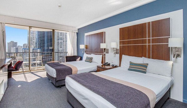 Desk, iron/ironing board, bed sheets