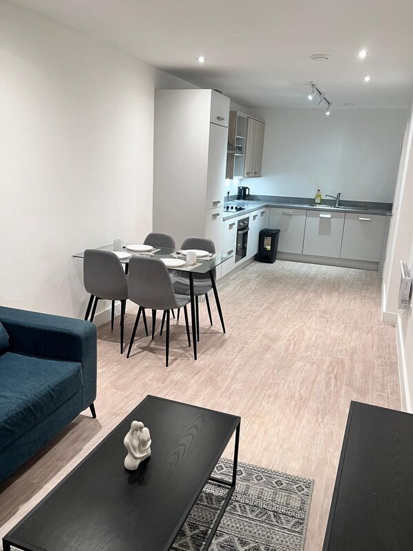 Cozy living space with a sofa, dining table, and kitchenette.