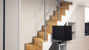 A modern kitchen with wooden stairs and a built-in TV. - Hotel Wavellent Yangyang (Yangyang)