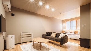 A modern living room with a sofa, a coffee table, and a TV. - BEPPU non (Beppu)