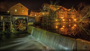 A historic building with a large water wheel and a restaurant named "Old Mill Restaurant." - Mountain Views/Fire Pit/Hot Tub/Game Room/Close 2 Strip (Sevierville)