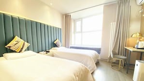 A hotel room with two beds, a desk, a chair, and a window with curtains. - Piaohome Chain Hotel (Beijing)