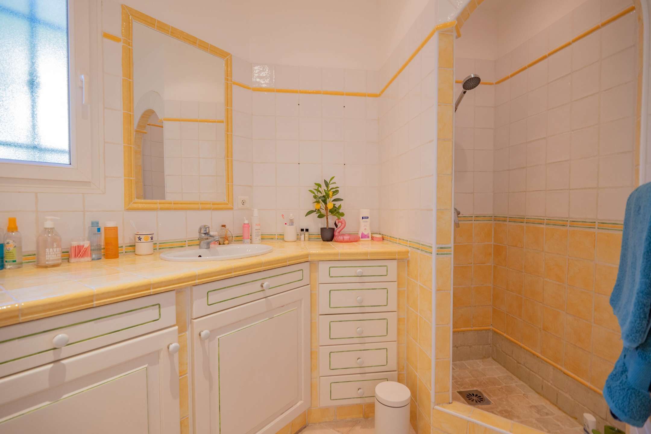 Een badkamer met twee wastafels, een spiegel, een douche en een toilet.