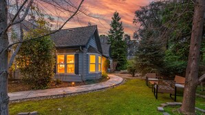 A house with a well-maintained lawn, a pathway leading to the entrance, and a bench in the yard. - Blue Resort of Yosemite-Pool, Hot Tub, Theatre and Games (Mariposa)