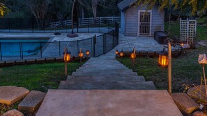 A backyard with a swimming pool, a small shed, and a staircase leading to a deck area. - Blue Resort of Yosemite-Pool, Hot Tub, Theatre and Games (Mariposa)