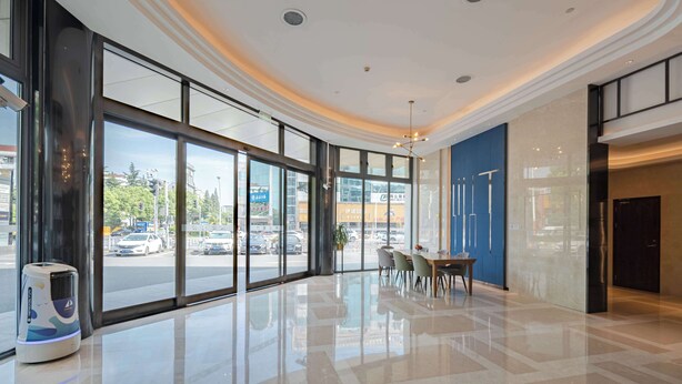 A modern hotel lobby with large windows, a polished floor, and a seating area. - U-FREE Hotel Shanghai Hongqiao Wuzhong (Shanghai)
