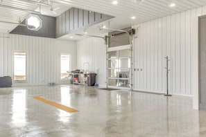 Experience the industrial-chic interior with exposed ductwork, polished concrete floor, and a spacious open area.