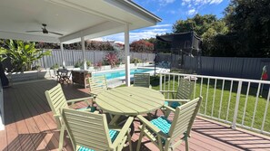 A covered outdoor patio with a pool, surrounded by a white fence and greenery. - Book 4 nights, Pay for 3 - School Holidays - Message to receive offer! (Kiama)