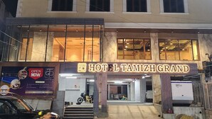 A multi-story hotel with a sign reading "HOTEL TAMIZH GRAND". - HOTEL TAMIZH GRAND (Puducherry)
