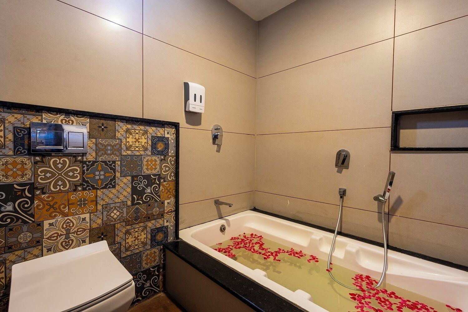A bathroom with a bathtub, shower, and a toilet.