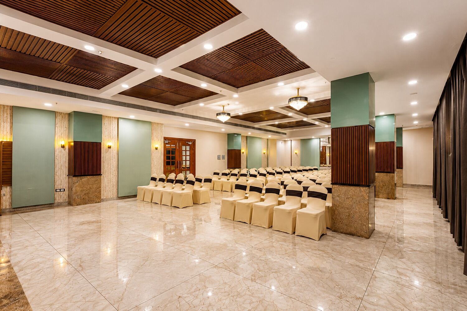 A conference room with rows of chairs, a wooden ceiling, and a marble floor.