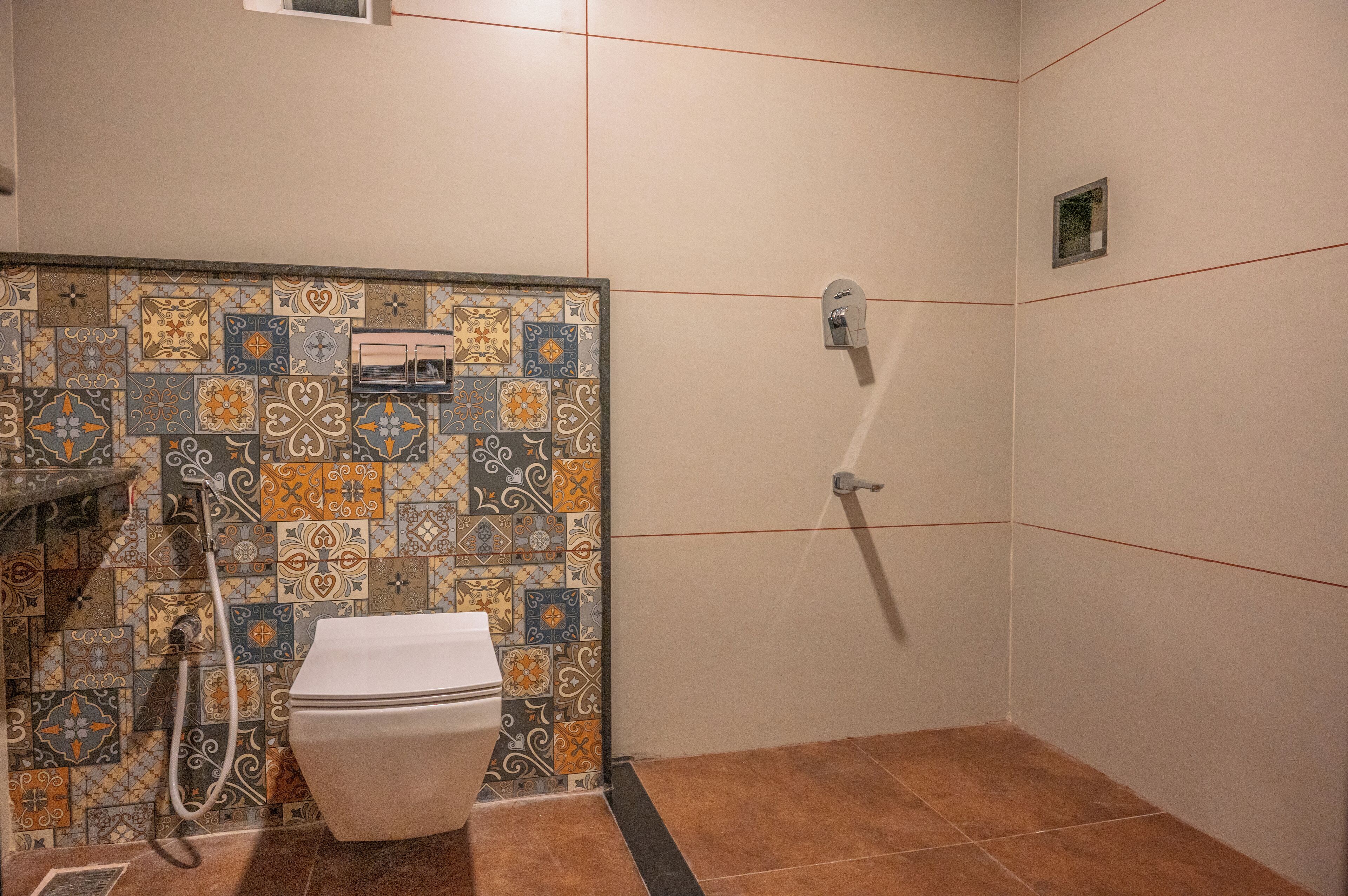 A bathroom with a toilet, shower, and tiled walls.