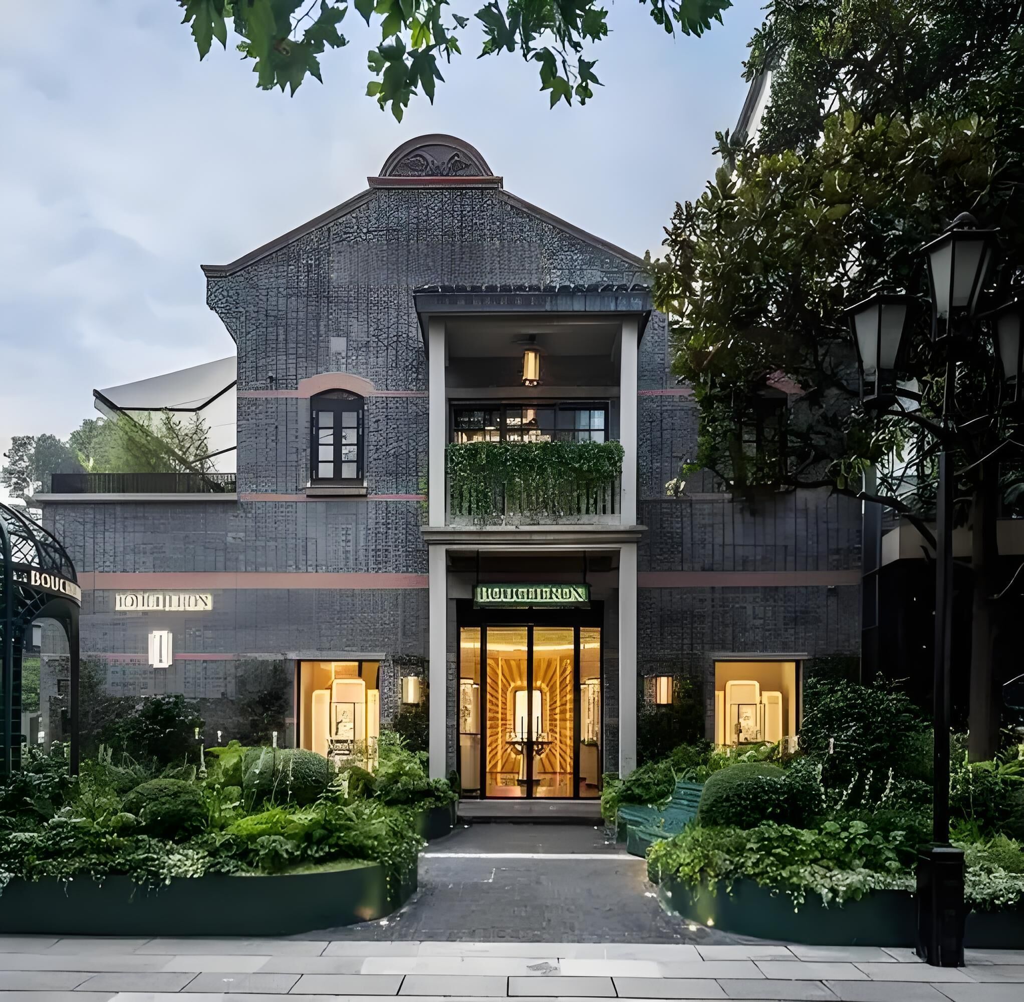 A two-story building with a boutique hotel sign, a balcony with greenery, and a well-maintained garden area.