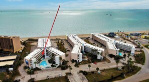 A hotel with multiple buildings, a swimming pool, and a beach view. - Private Balcony w/ Ocean View | Pool & Hot Tub Access | Ocean Echo by AvantStay (Corpus Christi)