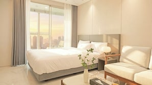 A modern hotel room with a large bed, a sofa, a nightstand, and a view of a cityscape. - SOTA SUITE Busan Seomyeon (Busan)