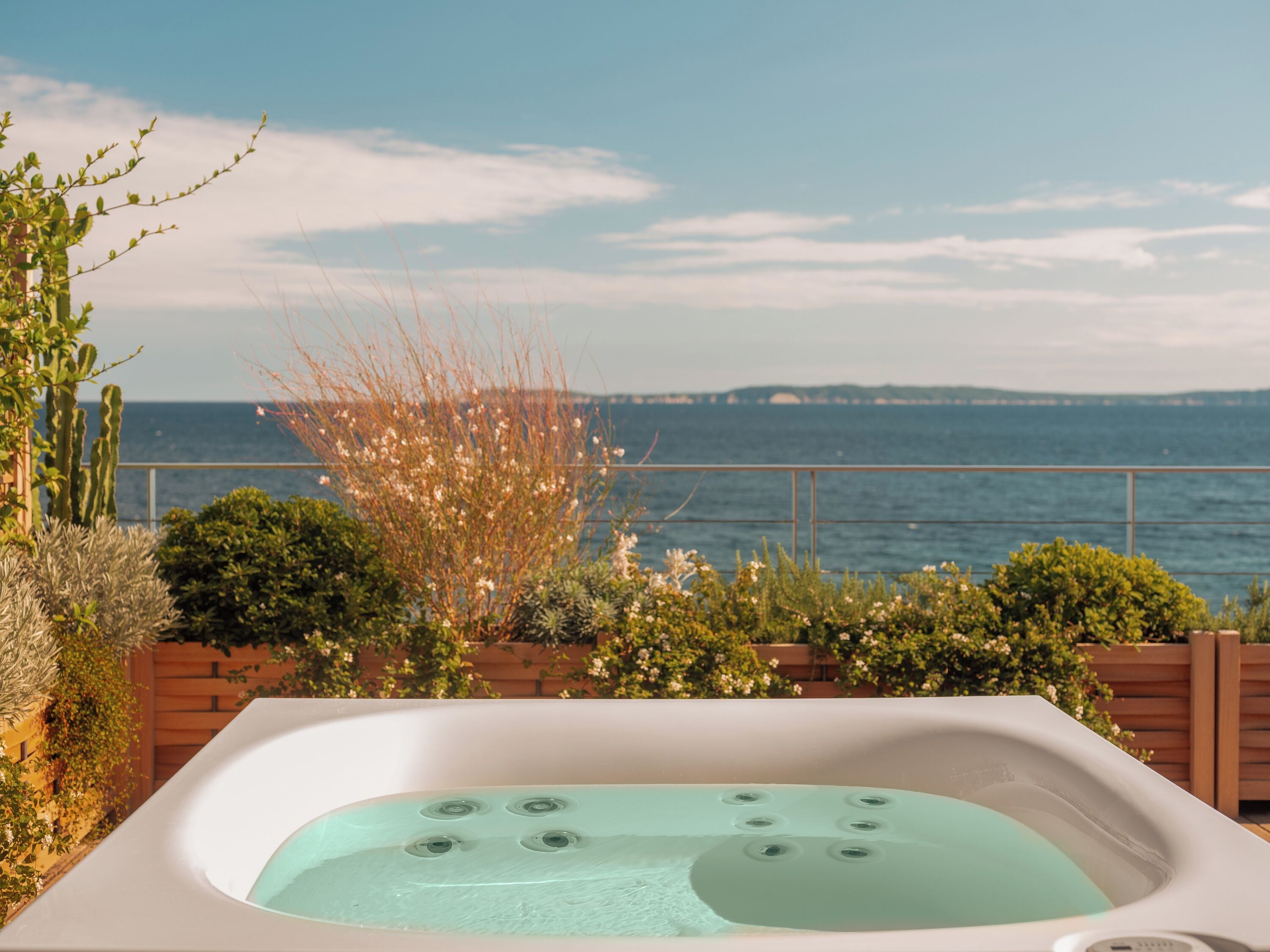 A hot tub with a view of the sea.
