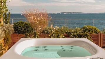 A hot tub with a view of the sea.