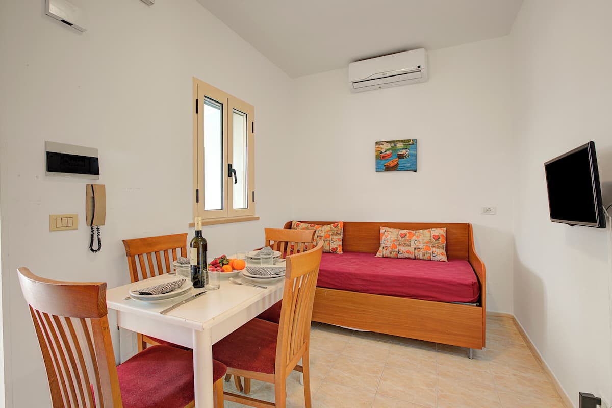 Family Apartment, 1 Bedroom (Stella Marina Apartment 6) | Living area | 21-inch Smart TV with cable channels