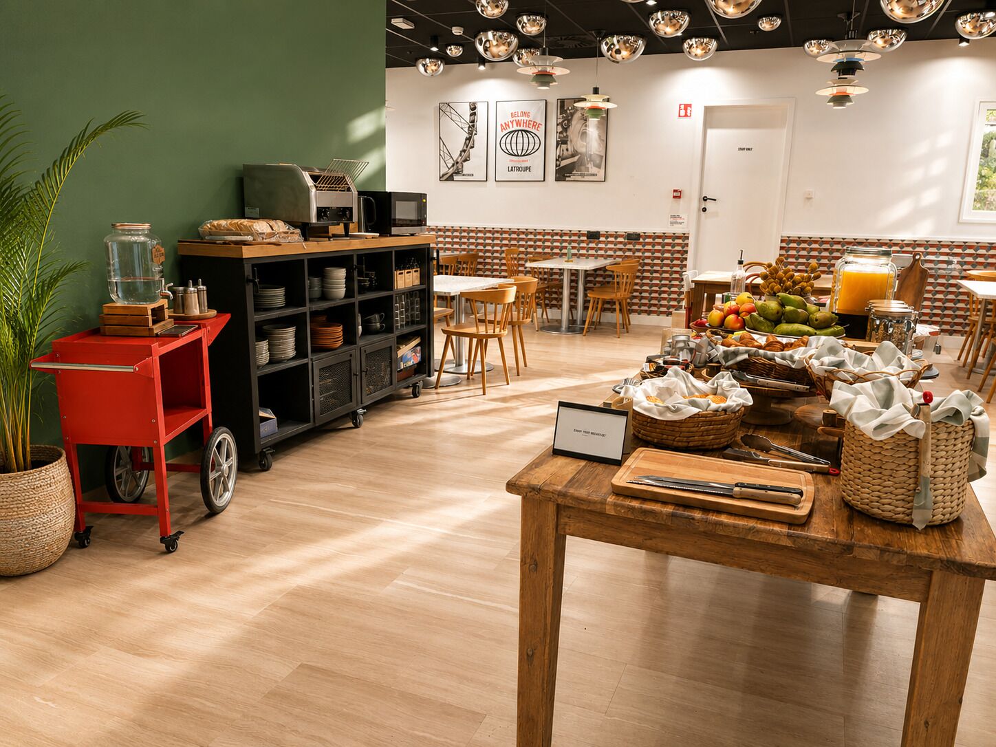 A café with a wooden table, a red cart, and a variety of food items.