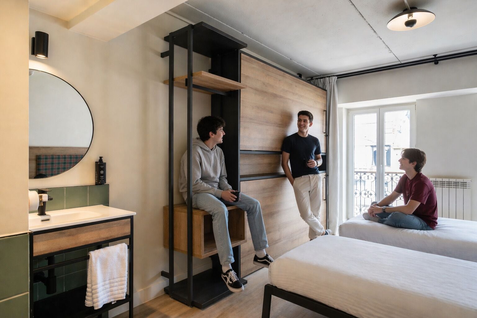 A modern room with a bed, a bench, a mirror, and a window.