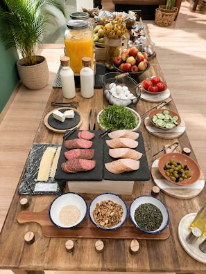 A breakfast buffet with various food items and condiments. - Latroupe Grand Place (Brussels)