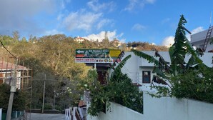 A signboard for RS Family Stay with a list of amenities including a restaurant, laundry, and parking. - RS Family Stay  (Kodaikanal)