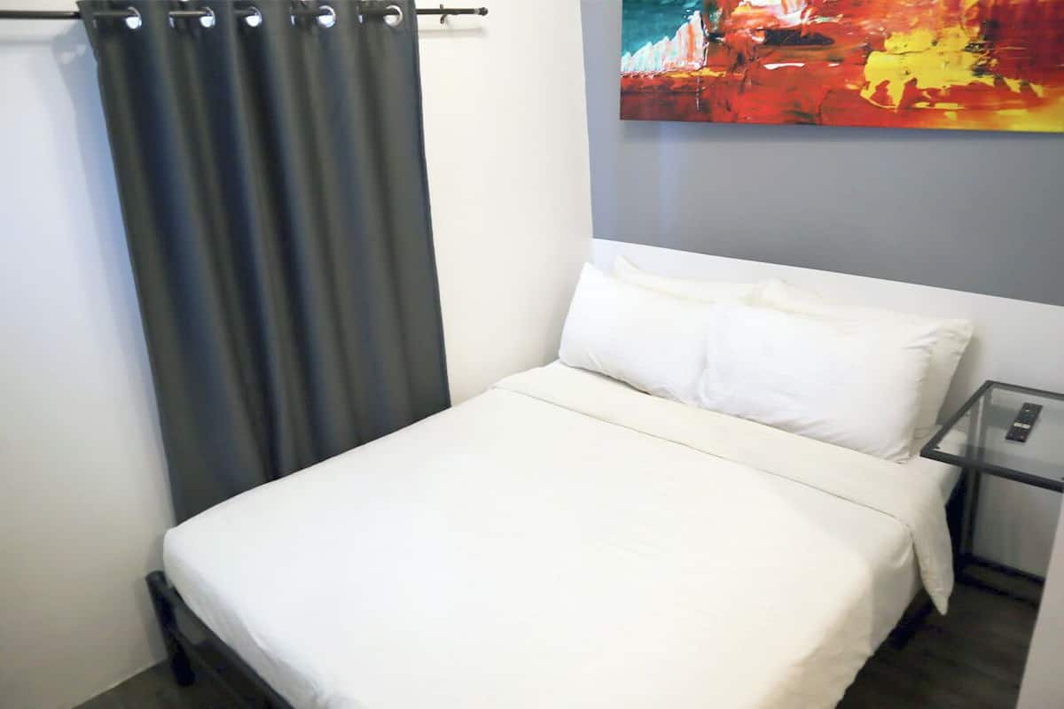 Deluxe Queen Room | Desk, laptop workspace, blackout drapes, iron/ironing board