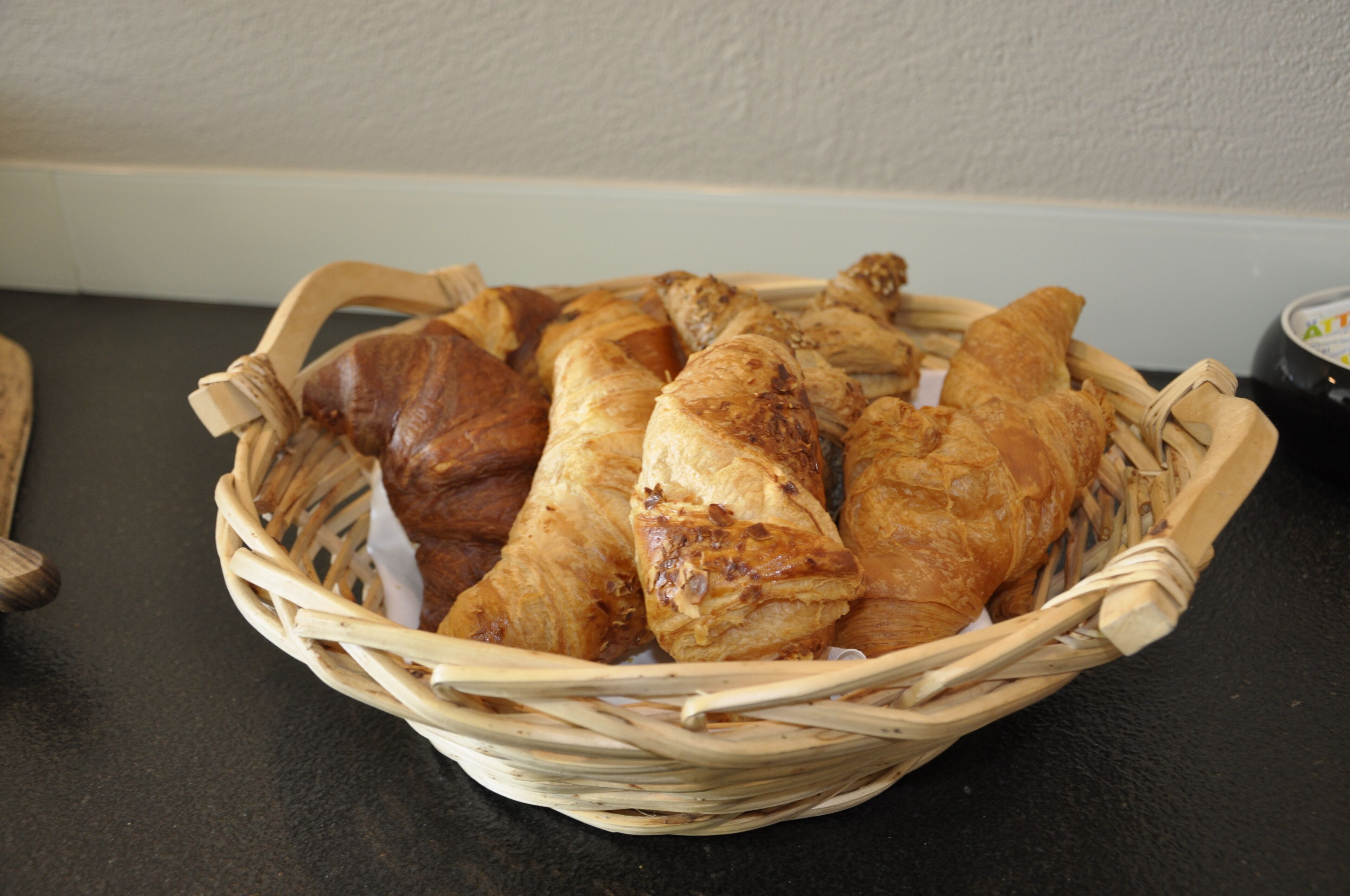 A basket of pastries on a table.