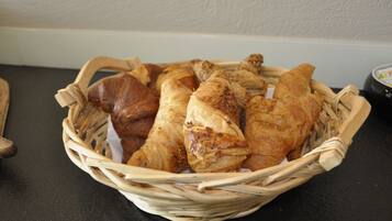A basket of pastries on a table.