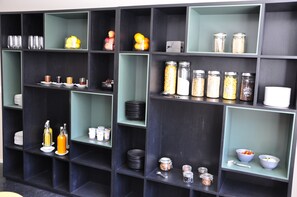 A kitchen with multiple shelves containing various kitchenware and food items. - Hotel zum Hirschen (Villigen)