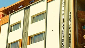 A building with a sign reading "Hotel Ganga Riverfront" and "Rooms & Banquet". - GANGA RIVERFRONT ROOMS AND BANQUET (Prayagraj)